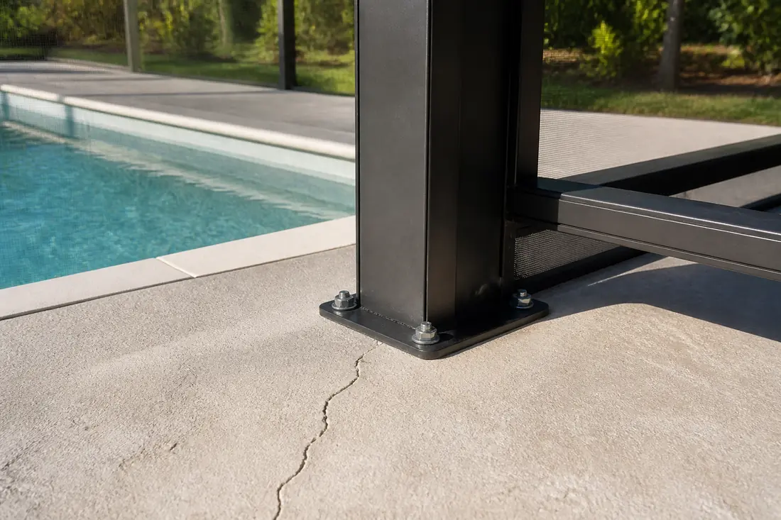 An aluminum upright base plate fixed to a concrete deck with anchor bolts
